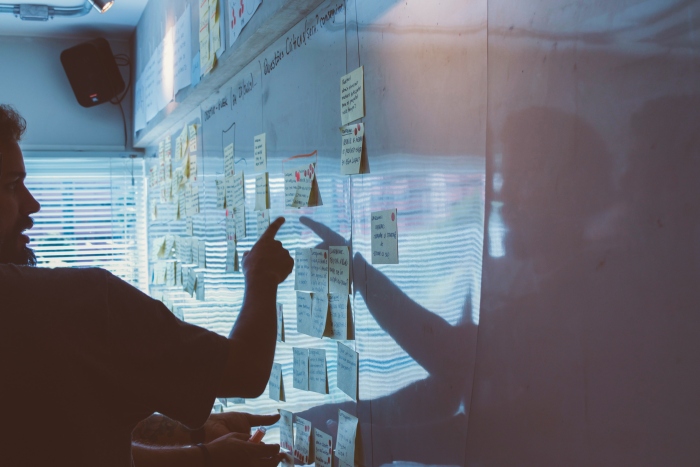 Unsplash a team going over a plan on a whiteboard