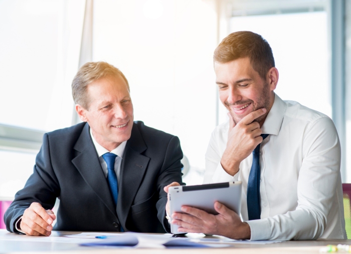 Freepik two businessmen discussing a digital tablet Freepik two businessmen discussing a digital tablet