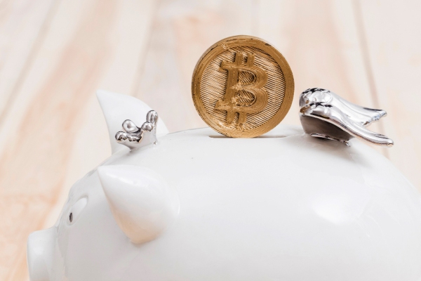 Freepik Golden bitcoin over white piggybank slot
