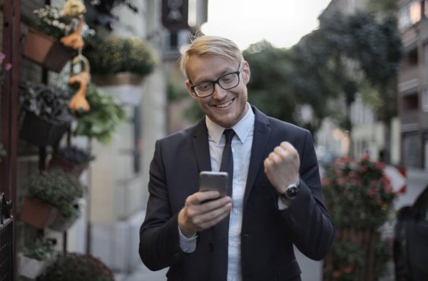 AI Image – Business professional celebrating success while using a smartphone